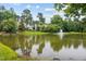 Picturesque view of a pond with a fountain and residential homes in the background at 304 Gold Point Dr, Cary, NC 27519