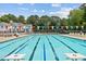 Spacious community pool featuring lane markers, lounge chairs, and colorful pennant flags at 304 Gold Point Dr, Cary, NC 27519