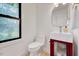 Modern half-bath featuring a unique sink and decorative window at 306 Roebling Ln, Cary, NC 27513