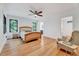 Spacious bedroom boasts hardwood floors, neutral walls, a ceiling fan, and a light wood bed frame at 306 Roebling Ln, Cary, NC 27513