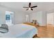 Bedroom featuring hardwood floors and a glimpse into the ensuite bathroom at 306 Roebling Ln, Cary, NC 27513