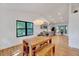 Open dining area features hardwood floors, gray cabinets, stainless appliances, modern lighting and large windows at 306 Roebling Ln, Cary, NC 27513
