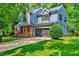 Charming two-story home with a manicured lawn, brick and gray siding, and attached garage in a wooded neighborhood at 306 Roebling Ln, Cary, NC 27513