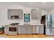 Modern kitchen featuring gray cabinets, stainless steel appliances, and hardwood floors at 306 Roebling Ln, Cary, NC 27513