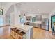 Open concept kitchen with stainless appliances, granite countertops, hardwood floors, an island with seating and pendant lights at 306 Roebling Ln, Cary, NC 27513
