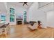 Bright living area with fireplace, comfortable seating, and hardwood floors at 306 Roebling Ln, Cary, NC 27513