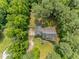 Aerial view of a charming house with lush green trees surrounding the property at 3304 Black Stallion Ct, Zebulon, NC 27597
