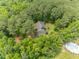 Aerial view of a wooded lot featuring a home, pool, and mature trees at 3304 Black Stallion Ct, Zebulon, NC 27597