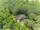 Aerial view shows home surrounded by lush, mature trees, offering privacy and shade at 3304 Black Stallion Ct, Zebulon, NC 27597