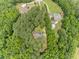 Aerial view of homes in a wooded area, showcasing a community with mature trees and private lots at 3304 Black Stallion Ct, Zebulon, NC 27597