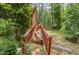 Backyard showing a ramp leading to the house, with wooden rails and a view of the surrounding greenery at 3304 Black Stallion Ct, Zebulon, NC 27597