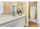 Bathroom featuring a white vanity with white countertop and chrome faucet, and a door to the toilet and shower at 3304 Black Stallion Ct, Zebulon, NC 27597