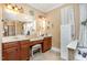 Bathroom featuring a vanity with wood cabinets, tile flooring and a separate shower and tub with neutral wall color at 3304 Black Stallion Ct, Zebulon, NC 27597