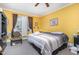 Bright bedroom with a ceiling fan, window with blinds, carpet and a comfortable queen-sized bed at 3304 Black Stallion Ct, Zebulon, NC 27597