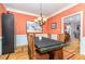 Formal dining room with elegant chandelier, hardwood floors, and decorative trim at 3304 Black Stallion Ct, Zebulon, NC 27597