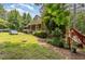 Home with landscaped grounds and a classic brick exterior, framed by mature trees at 3304 Black Stallion Ct, Zebulon, NC 27597
