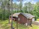 Rear elevation of a brick home with a screened porch, and attached garage at 3304 Black Stallion Ct, Zebulon, NC 27597