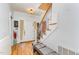 Foyer featuring wood floors, a staircase, front door, and a bench at 3304 Black Stallion Ct, Zebulon, NC 27597