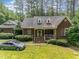 Inviting two-story brick home with a cozy front porch and mature trees at 3304 Black Stallion Ct, Zebulon, NC 27597
