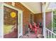 Cozy front porch with seating, brick accents, and a charming entry door at 3304 Black Stallion Ct, Zebulon, NC 27597