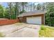 Exterior showcasing a two-car garage with a wide driveway and partial wooden fence at 3304 Black Stallion Ct, Zebulon, NC 27597