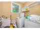 Functional laundry room with a washing machine, dryer, sink, and storage shelves, providing convenience at 3304 Black Stallion Ct, Zebulon, NC 27597