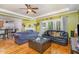 Cozy living room featuring hardwood floors, French doors, and a fireplace, providing a warm gathering space at 3304 Black Stallion Ct, Zebulon, NC 27597