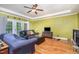 Bright living room with hardwood floors, a ceiling fan, and French doors, offering a comfortable space at 3304 Black Stallion Ct, Zebulon, NC 27597