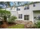Back exterior view showcasing a patio and sliding glass door, surrounded by lush greenery and landscaping at 3519 Sugar Tree Pl, Durham, NC 27713