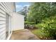 Backyard features a sliding door and a lawn with trees and a bush at 3519 Sugar Tree Pl, Durham, NC 27713