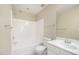 Clean bathroom features a shower-tub combo, white fixtures, and a neutral color palette at 3519 Sugar Tree Pl, Durham, NC 27713