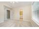 Bright bedroom with neutral carpet features a ceiling fan and ensuite bathroom access at 3519 Sugar Tree Pl, Durham, NC 27713