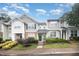 Charming townhome featuring manicured landscaping and inviting green front door under a cloudy blue sky at 3519 Sugar Tree Pl, Durham, NC 27713