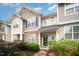 Charming townhome featuring manicured landscaping and inviting green front door under a cloudy blue sky at 3519 Sugar Tree Pl, Durham, NC 27713