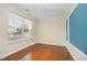 Bright living room features hardwood floors, large window, and wainscoting at 3519 Sugar Tree Pl, Durham, NC 27713