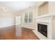 Bright living room featuring hardwood floors, fireplace, and sliding glass doors at 3519 Sugar Tree Pl, Durham, NC 27713