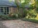 Backyard patio area of brick pavers surrounded by lush landscaping at 3604 Woodlawn Rd, Rocky Mount, NC 27804