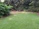 Manicured backyard with lush green grass and landscaped border at 3604 Woodlawn Rd, Rocky Mount, NC 27804