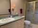 Bathroom vanity featuring green countertop and tiled shower with glass door at 3604 Woodlawn Rd, Rocky Mount, NC 27804