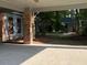 Attached carport area with a glimpse of the landscaped yard and a separate outdoor building at 3604 Woodlawn Rd, Rocky Mount, NC 27804