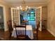 Dining room with chandelier and views to backyard through open french doors at 3604 Woodlawn Rd, Rocky Mount, NC 27804