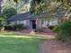 Traditional brick home with charming curb appeal, a well-manicured lawn and the American flag at 3604 Woodlawn Rd, Rocky Mount, NC 27804