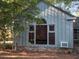 Exterior view of home's side featuring a large window and partial brick foundation at 3604 Woodlawn Rd, Rocky Mount, NC 27804
