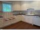 Bright kitchen with white cabinets, stainless appliances, and a window seat overlooking the yard at 3604 Woodlawn Rd, Rocky Mount, NC 27804