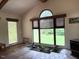 Bright living room with terracotta tile floors, large windows, and view to the yard at 3604 Woodlawn Rd, Rocky Mount, NC 27804