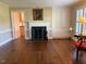 Cozy living room boasts hardwood floors, a fireplace, built in cabinetry, and natural light at 3604 Woodlawn Rd, Rocky Mount, NC 27804