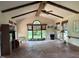 Spacious living room with high ceilings, beam, and natural light streaming through large windows at 3604 Woodlawn Rd, Rocky Mount, NC 27804