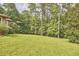 Beautiful green lawn and mature trees in the backyard offer privacy and a serene setting at 3605 Laurel Creek Way, Durham, NC 27712