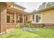Beautiful backyard with a covered porch, brick accents, and a lush lawn at 3605 Laurel Creek Way, Durham, NC 27712