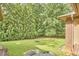Lush backyard with mature trees and landscaping, perfect for outdoor activities and relaxation at 3605 Laurel Creek Way, Durham, NC 27712